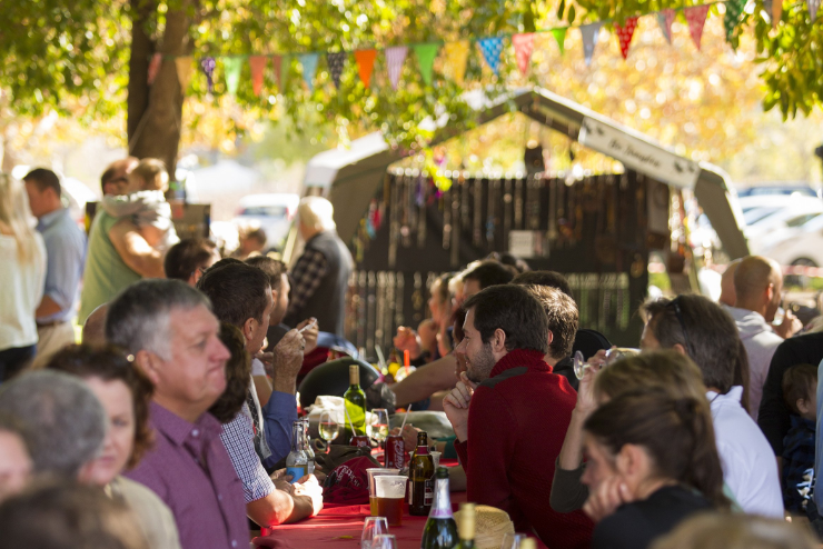 People sitting on a bench at the Blaauwklippen Twilight Gift Market