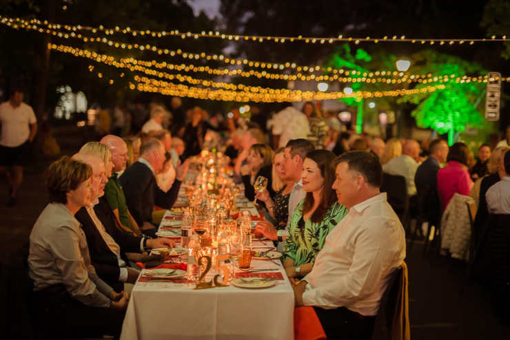 People sitting at a long dining table